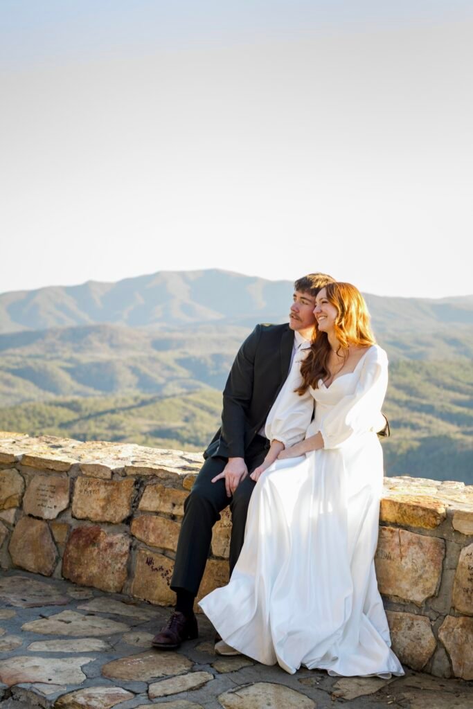 A couple on their elopement day sitting at an overlook in the Cherokee National Forest